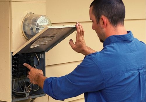 Service Panel Upgrades - DK Electrical Solutions Inc. Electrician working on the service pannel for a home - DK Electrical Solutions Inc.